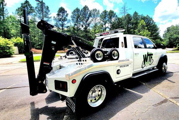 WTF Towing Ram 5500 wrecker with Jerr-Dan wheel-lift on a Cary, NC road