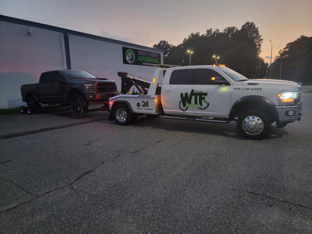 WTF Towing wrecker towing a truck at dusk