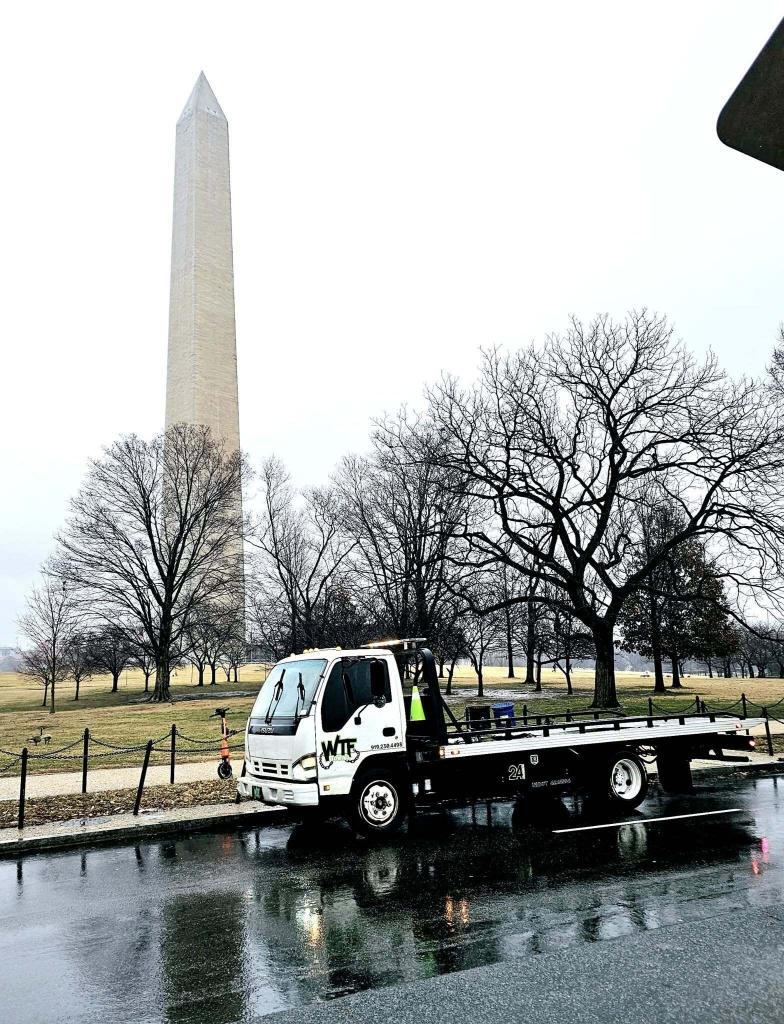 WTF Towing rollback carrier on a long-distance tow near the Washington Monument