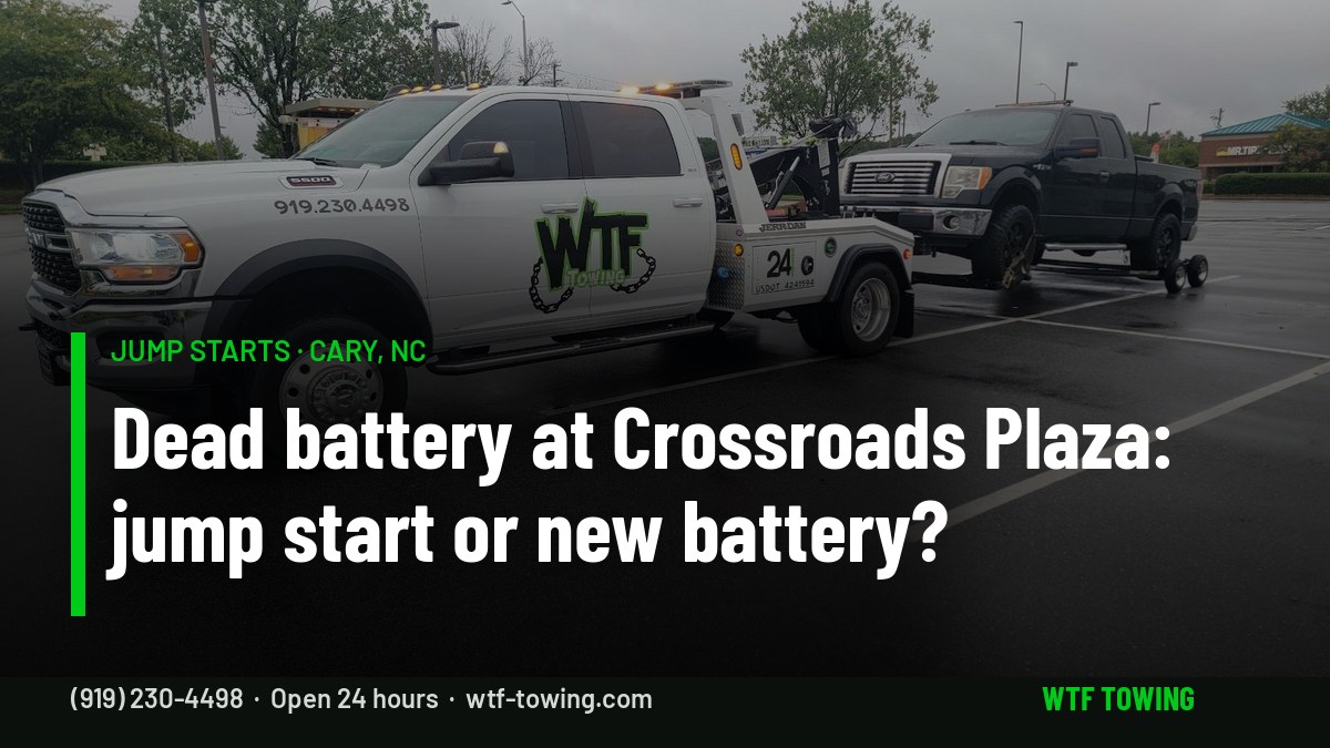 WTF Towing Ram wrecker in a shopping-center parking lot in Cary, NC — jump start service for dead batteries at Crossroads Plaza and other Cary lots