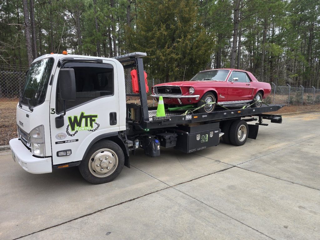WTF Towing flatbed hauling a classic red Mustang near Cary, NC