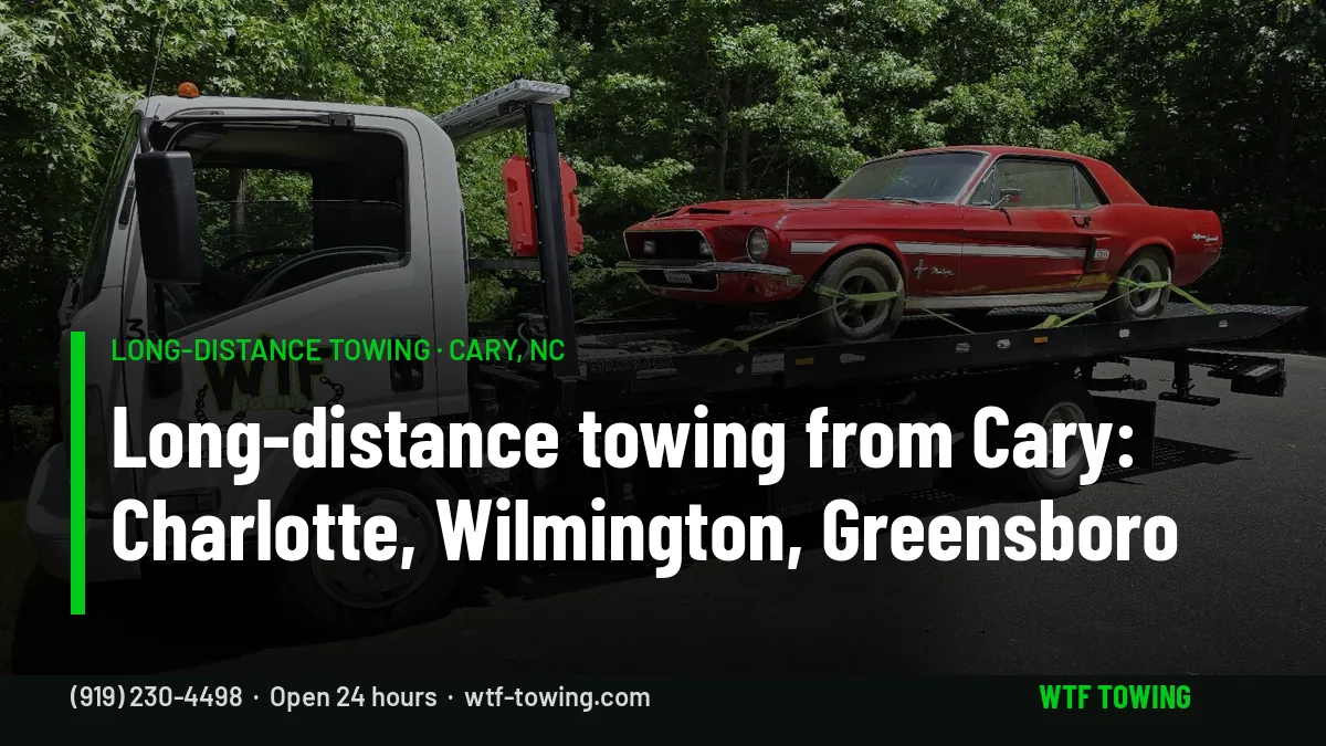 WTF Towing rollback carrier with a red classic Mustang strapped down on its flatbed on a tree-lined road - long-distance towing from Cary, NC to Charlotte, Wilmington and Greensboro